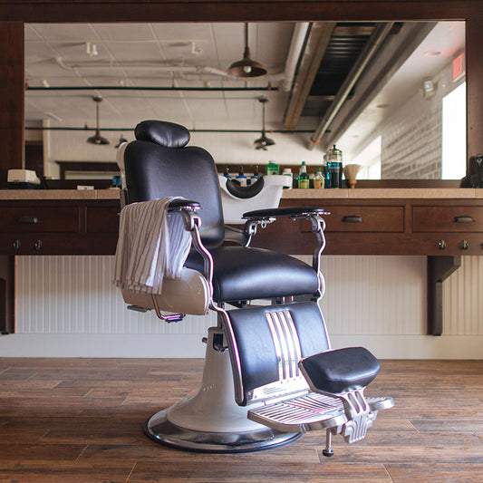 Takara Belmont Koken Legacy barber chair with black vinyl upholstery at a grooming station