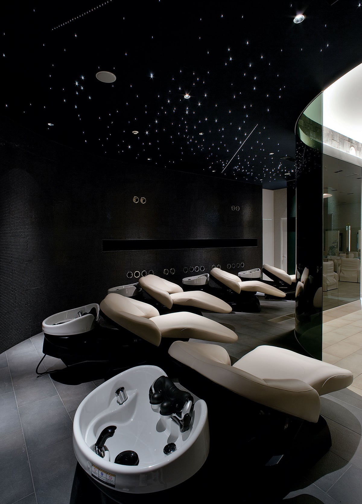 Takara Belmont YUME head spa units in a dimly lit spa treatment space