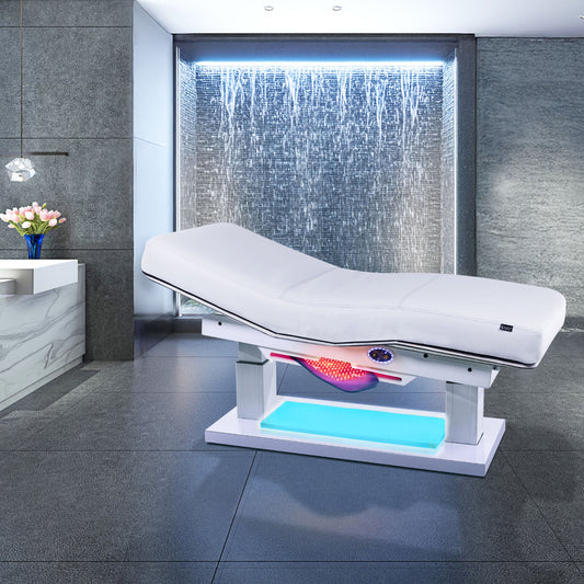 Living Earth Crafts Cascade treatment table with blue base lighting in front of a waterfall wall