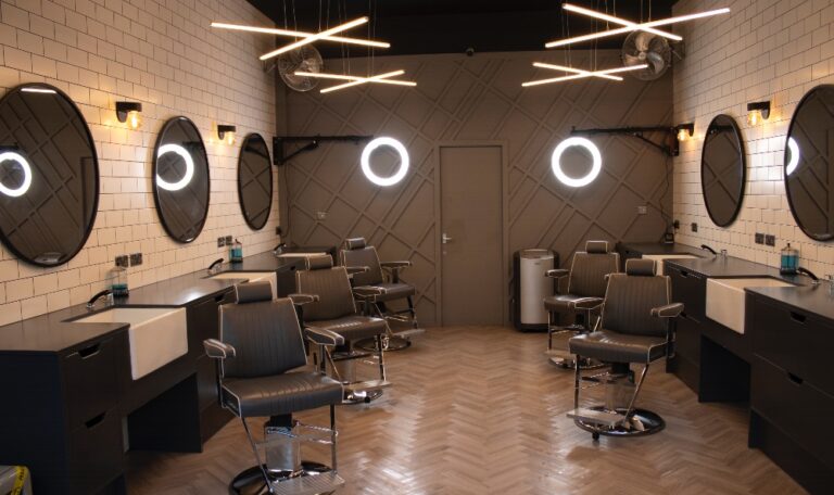 Takara Belmont Dainty barber chairs in a barbershop with round mirrors
