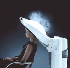 Client seated beneath a Takara Belmont Micromist processor with mist rising from the hood