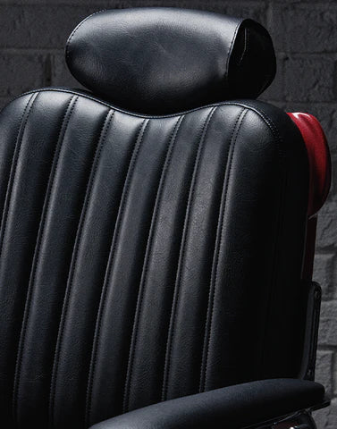 Black stripe-stitched backrest and headrest on the Legacy 100 Vintage Stripe barber chair