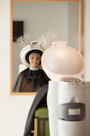Takara Belmont Micromist processor beside a client at a salon mirror