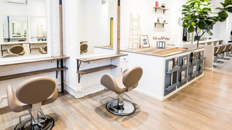 Takara Belmont Novo chairs in a bright salon with white stations and wood flooring