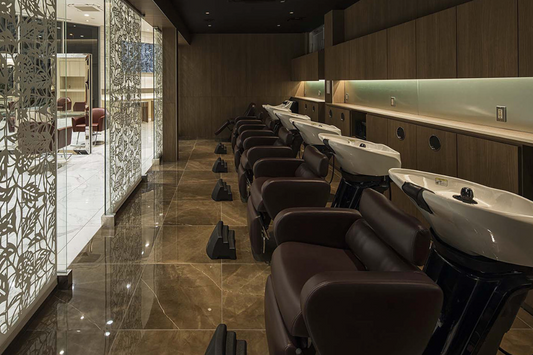 Takara Belmont RS Primo shampoo units along a wood-paneled salon wall