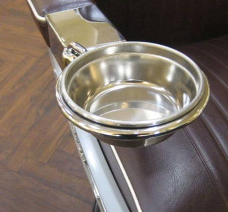 Optional metal manicure bowl attached to a Takara Belmont barber chair armrest