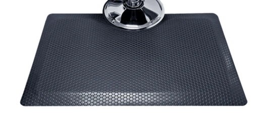 Nickels Worth textured rectangular salon and barber mat around a chair base