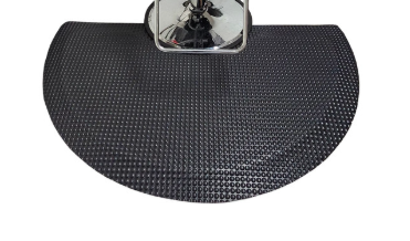 Nickels Worth textured round salon and barber mat around a chair base