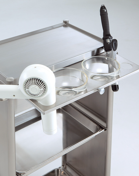 Hair dryer and styling iron stored in the tool holder on a Takara Belmont D Galley salon wagon