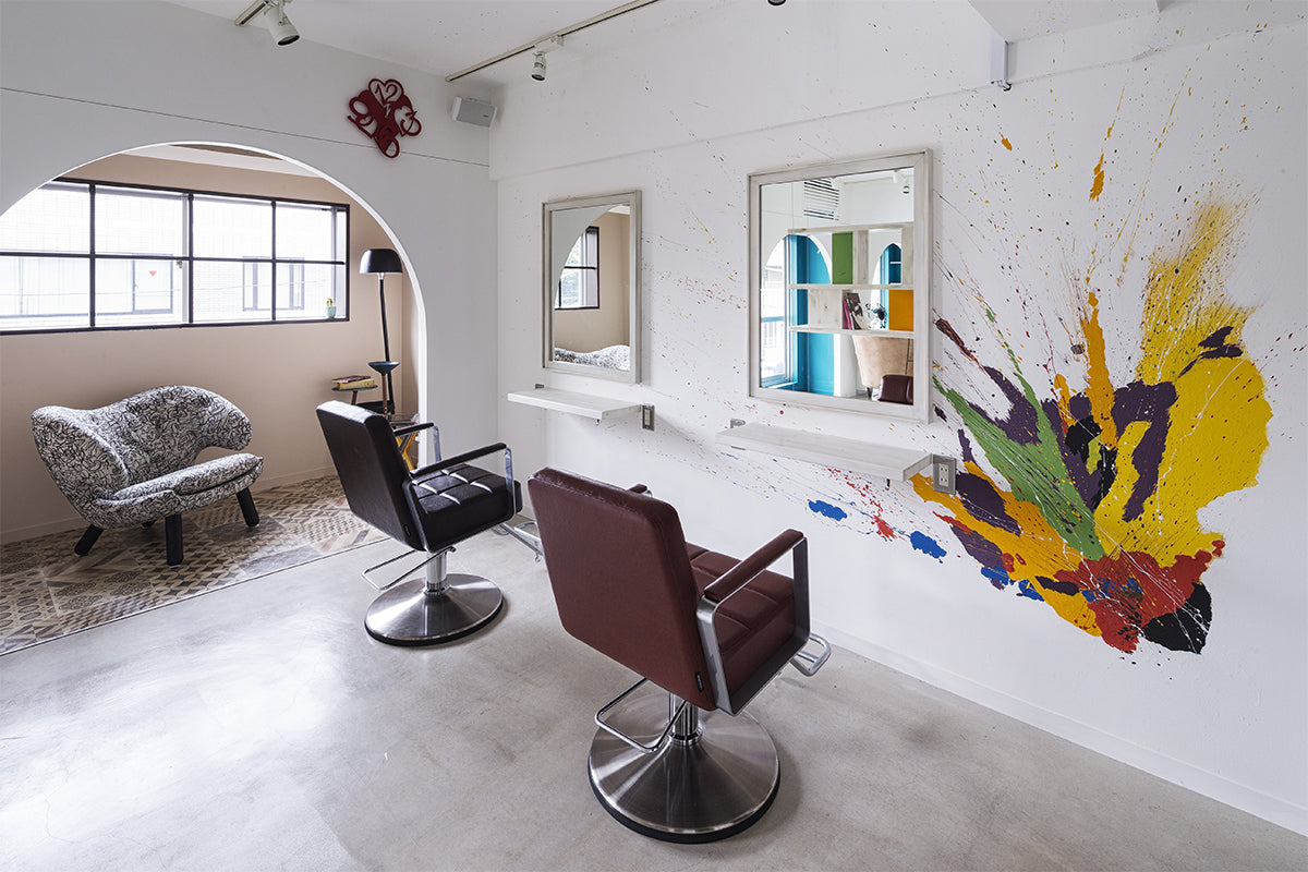 Takara Belmont Choco styling chairs in a salon with colorful wall art
