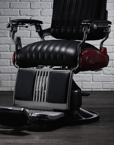 Front view of the Legacy 100 Vintage Stripe barber chair with black upholstery and metallic red body
