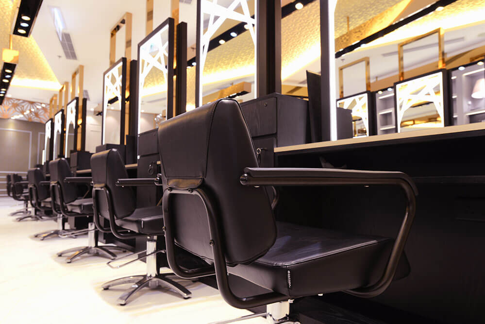 Takara Belmont Prime styling chairs lined up beside illuminated salon mirrors