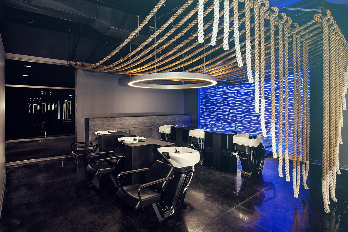 Takara Belmont RS Prime shampoo units in a dark salon with blue accent lighting