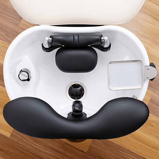 Overhead view of the YUME lash device, pillow and accessory tray fitted to a shampoo bowl
