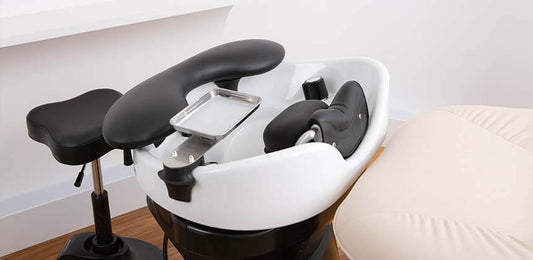 YUME lash device and pillow fitted to a shampoo bowl with a technician stool alongside