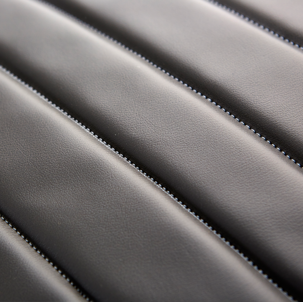 Close-up of the stitched upholstery on a Takara Belmont Ghia styling chair