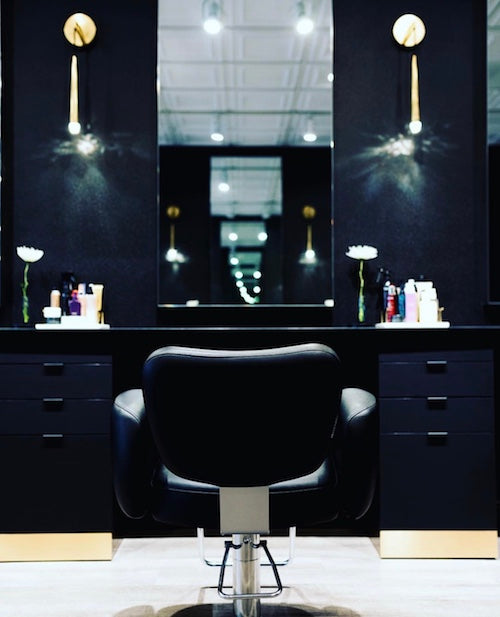 Takara Belmont Bellus styling chair at a black salon mirror station